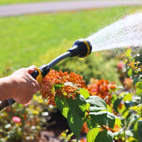 Relax Grip 15 Inch Garden Hose Wand With 8 Pattern Sprayer And Easy Thumb Control Adaptor in use watering plants
