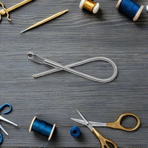Foldable Drawstring Threaders Kit with Latch Hook 20 pieces on wooden table with scissors, blue threads, and crochet hook.