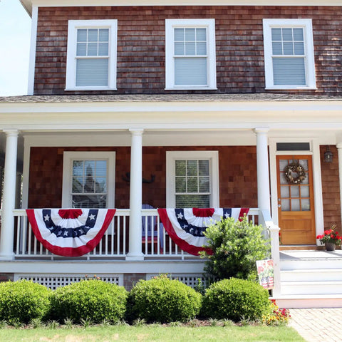 Patriotic Bunting Flags Set Of 6 Three Foot Long Outdoor Indoor Decoration Flags With Brass Grommets for Fourth of July displayed on porch.