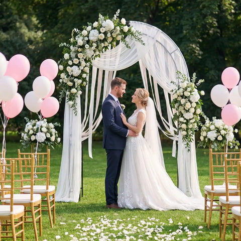 7.2 Ft Outdoor Steel Garden Arch Arbor With Stakes at wedding ceremony, decorated with flowers and white fabric, surrounded by balloons