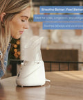Woman using Steam Inhaler For Fast Drug Free Congestion Relief With Adjustable Steam Control, Universal Mask on wooden table
