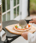 Person using Pizza Cutter Wheel With Durable 304 Stainless Steel Blade And Powder Coated Aluminum Handle Dishwasher Safe Easy Grip For Quick Slices Perfect For Sharing With Family And The Crew Pi Collection on pizza