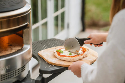 Person using Pizza Cutter Wheel With Durable 304 Stainless Steel Blade And Powder Coated Aluminum Handle Dishwasher Safe Easy Grip For Quick Slices Perfect For Sharing With Family And The Crew Pi Collection on pizza