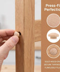 Hand inserting 120Pcs Wood Screw Hole Plugs With Top for Wooden Furniture Hole Covers, natural grain finish, into wood surface