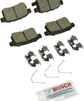 Bosch BC1451 QuietCast rear ceramic brake pad set with four pads, clips, and lubricant packet.