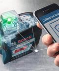 Boss Class 12V Max Three Plane Green Beam Laser Level with Bluetooth app for calibration check visible on smartphone.