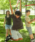 Kids playing on Ninjaline Obstacle Course Kit For Backyard Ninja Warrior Training 56 Ft Deluxe Set with rings and monkey bars