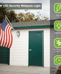 Ultra Bright LED Wall Pack Light Outdoor Security Wall Mount Fixture 28W 3000LM 4000K Daylight Dusk-to-Dawn Photocell 120-277V UL Listed 4 Pack Energy-Saving Porch And Garage Lighting illuminating a garage with an American flag.