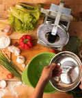 Person using 11Lb Analog Mechanical Kitchen Scale With Stainless Steel Bowl Tare Function Old School Retro Style Durable Dial Easy Clean Precise Food Weighing For Baking And Cooking next to fresh vegetables.