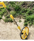 Collapsible Mechanical Distance Measuring Wheel for Construction, yellow wheel, compact design for easy measuring.