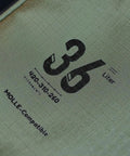 Close-up of fabric label showing 36 liter capacity of 36L Travel Duffle Bag With Shockproof Storage System Lightweight Camping Gear Organizer