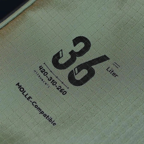 Close-up of fabric label showing 36 liter capacity of 36L Travel Duffle Bag With Shockproof Storage System Lightweight Camping Gear Organizer