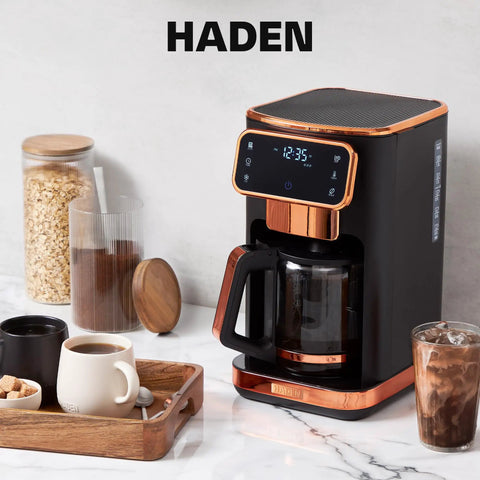 Heavy Duty 12 Cup Dual Brew Coffee Maker Built For Hot And Cold Brewing, sleek black with copper accents on kitchen counter.