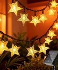 Solar Star String Lights 39Ft Outdoor Waterproof Fairy Lights With 100 LEDs, 8 Modes hanging in garden with warm white glow