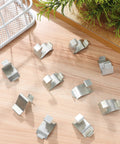 Heavy Duty Metal Shelf Clips With Super Sturdy Adjustable Mounts For Closets And Bookshelves arranged on wood surface.