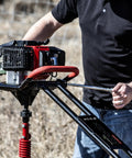 1-Man Earth Auger Powerhead With Sidekick Auger Torque Reducer For One-Man Operation in outdoor grass field