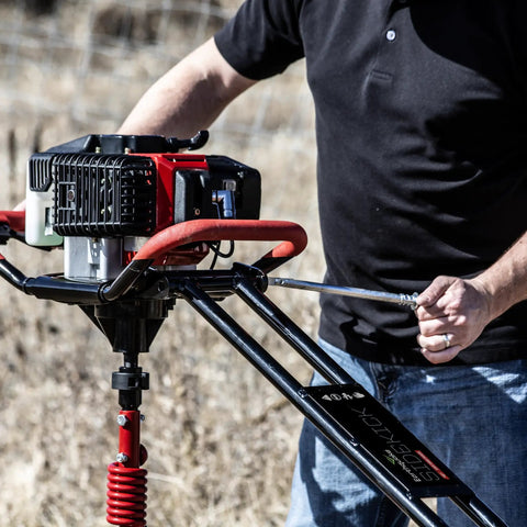 1-Man Earth Auger Powerhead With Sidekick Auger Torque Reducer For One-Man Operation in outdoor grass field