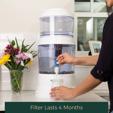 Person using Replacement Filter For Gravity Water System That Reduces Fluoride And Chlorine, Builds Alkaline Water, Adds Essential Minerals