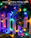 60 LED Cherry Blossom Solar String Lights Outdoor Waterproof Fairy Lights decorating a garden fence in multicolor