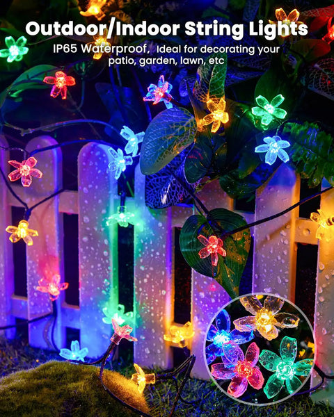 60 LED Cherry Blossom Solar String Lights Outdoor Waterproof Fairy Lights decorating a garden fence in multicolor