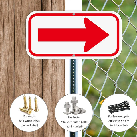 Two Pack Red And White Arrow Signs 12X6 Inch Heavy Duty Aluminum Reflective Directional Markers affixed to wood and chain link fence.