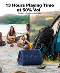Portable Bluetooth Shower Speaker Waterproof IPX7 With Loud Stereo Sound And Bass displayed on beach next to tent and backpack