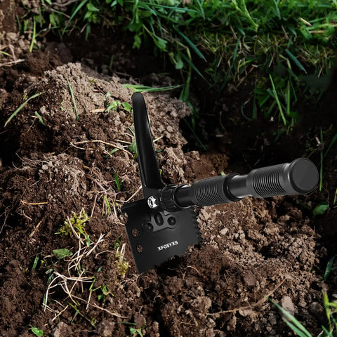 Ultralight Folding Camping Shovel Multitool with digging saw and pick in soil, handle extended, high carbon steel blade.