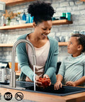 Smooth Operator Brushed Nickel Kitchen Faucet With Pull Down Sprayer Providing Three Versatile Flow Settings And A Flexible Swivel Spout For No Sweat Cleaning in use with a mother and daughter.