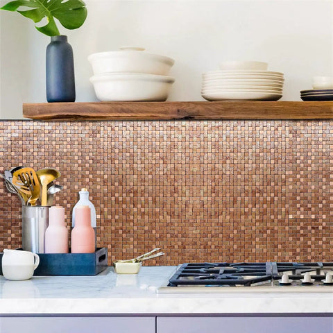Self Adhesive Aluminum Mosaic Backsplash Tiles Five Sheet Set for Kitchen Walls and More Peel and Stick Silver Stainless Steel Look with Textured Metal Finish Easy DIY Installation Modern Home Decor, installed in a kitchen, showing a neat pattern above a countertop with utensils and pot.