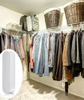 Walk-in closet with clothing and 4 Pack Plastic Rod Spacer Caps for Closet Rods and Wire Shelves End Caps on wire shelves.
