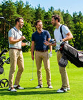 Three men holding golf clubs on a course with Two Pack Golf Ball Bags With Drawstring Nylon Mesh Pouches visible on the golf bag.