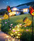 Cool Solar Watering Can With Lights For Outdoor Decor casting warm patterns on grassy pathway with butterfly and LED fairy lights
