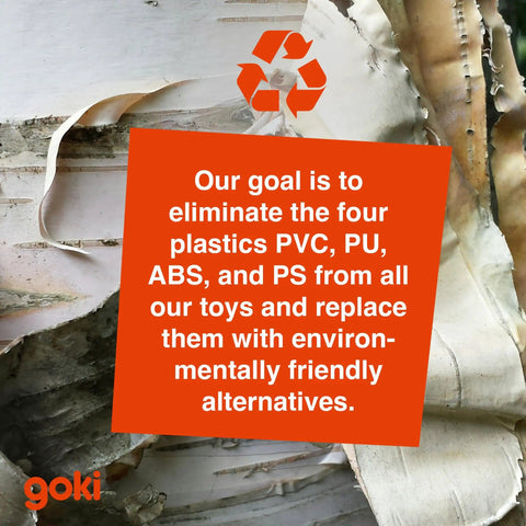 Environmental message about eliminating PVC, PU, ABS, and PS from toys, displayed on tree bark background with Goki logo.