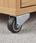 Low Profile Side Mount Caster Wheels Kit with brown rolling caster and metal bracket under wooden furniture on carpet