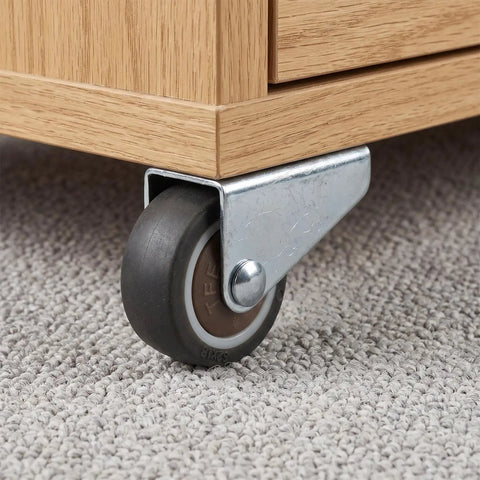 Low Profile Side Mount Caster Wheels Kit with brown rolling caster and metal bracket under wooden furniture on carpet