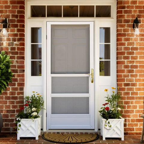 Tough As Nails Brass Storm And Screen Door Handle Set With Solid Lock and Key on a white storm door with flowers.