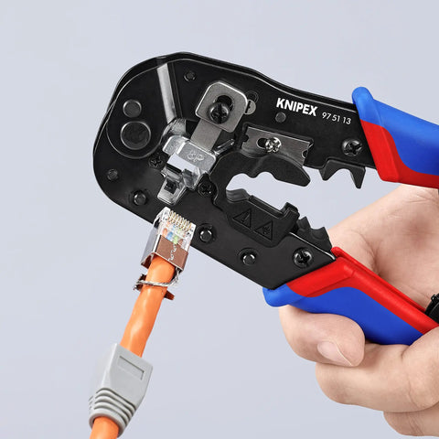 Hand using RJ45 Western Plug Crimping Pliers, 7 And A Half Inch, 8P8C Pro Grade Network Tool for crimping shielded plug on orange cable.