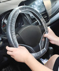 Hands placing a 100 Pack Disposable Steering Wheel Cover With Elastic Fit on a car wheel for spill protection and clean rides.