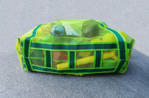 Green Must-Have Mesh Beach Toy Bag With Zipper Top filled with yellow beach toys, designed for easy carry and quick dry.