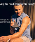 Man using Mini Plus Massage Gun With Heat For Faster Recovery On The Go, showcasing ergonomic design for deep tissue relief.