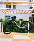 Double Snatch Block And Tackle Pulley System With Thirty Two Feet Of One Quarter Inch Rope And Hook hanging a bike in an outdoor rack