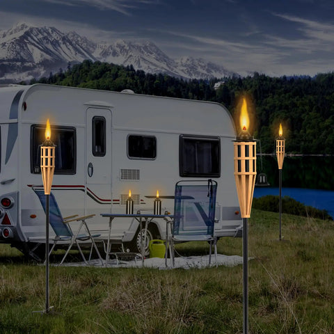 Outdoor scene with lit bamboo tabletop torches near a camper, featuring 16 Ounce Torch Replacement Canisters for Refillable Bamboo Torch Fuel Citronella Tabletop Torches Outdoor Patio Garden Decor Black No Fuss Easy Pour Wide Mouth Design with Snuff Cap for Safe Extinguishing.