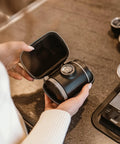 Person holding Picopresso Portable Espresso Maker Bundle With Protective Case for pro level coffee on the go.