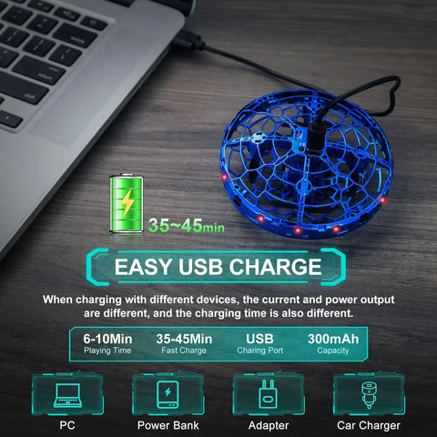 Hand Operated Flying Toy Drone For Kids With Gesture Control And 360 Degree Motion Sensors LED Lights Easy Indoor UFO Ball Drone For Ages 6 To 10 And Up Kid Friendly Blue shown with USB cable connected to laptop, highlighting quick charging feature.