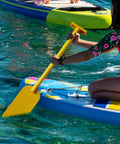 Child using Kids PVC Boat Paddle Prop For Water Sports Fun Yellow 50cm Lightweight Paddle Accessory For Festivals Races Dragon Boat Dances And Performances Colorful Kid Friendly Toy Gear For Kindergartens And Pools on water surface