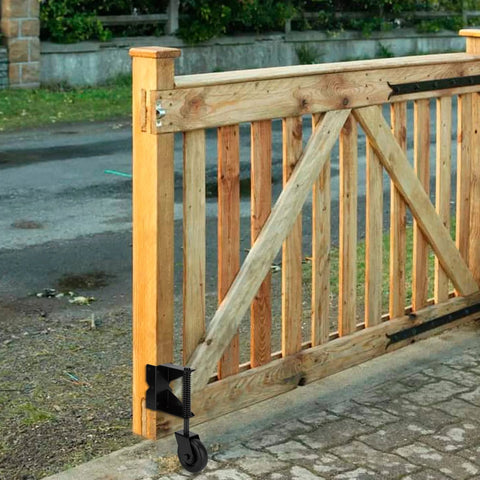 Spring Loaded Gate Caster For Wooden Gates And PVC Fences With 4 Inch Wheel, installed on a wooden gate.