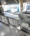 Inside view of Fully Equipped Compact Concession Food Trailer Mobile Kitchen For Street Vending with stainless steel workspace and appliances.