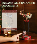 3D Wooden Puzzle Gravity Swing Santa On Sleigh Desktop Decor With Dynamic Balance For The Holidays, Festive Puzzle Gift For The Fam And Friends, Fun Desk Ornament That Swings Smoothly Into Perfect Equilibrium. Wooden Santa sleigh balance ornament on desk with hand pointer and stand