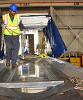 Worker securing cargo on flatbed with Binder Chain With Grab And Sling Hooks Grade 70 Standard Duty Three Eighths Inch By Eight Foot 6600 Pound Safe Working Load Heavy Duty Cargo Tie Down For Trucks Trailers And Flatbeds