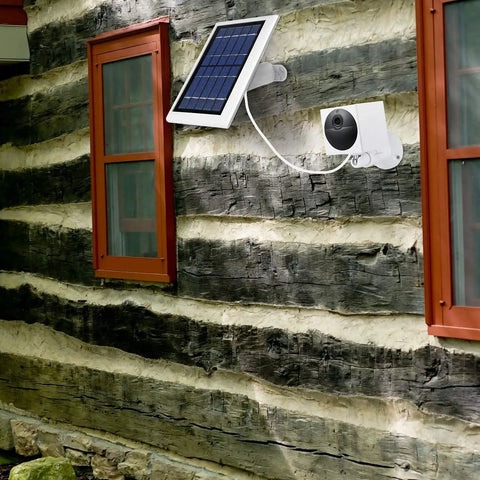 Wyze Cam Outdoor Solar Panel 3 Pack White, 2W 5V Charging mounted on a rustic wall powering camera, weatherproof setup